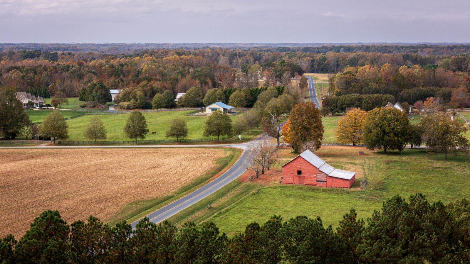 Piedmont North Carolina countryside in autumn with red barn and horse pasture