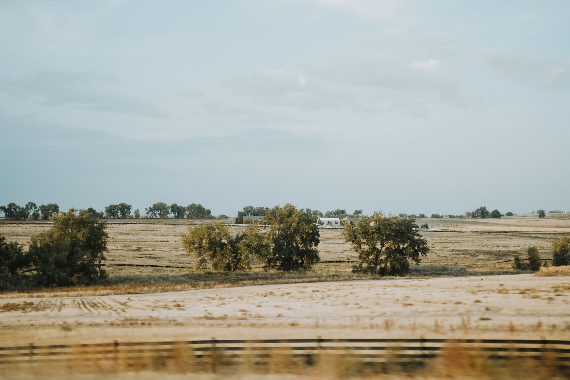 Open rangeland and rural acreage in Colorado under a wide sky, representative of Eastern Plains grazing and dryland farm country.
