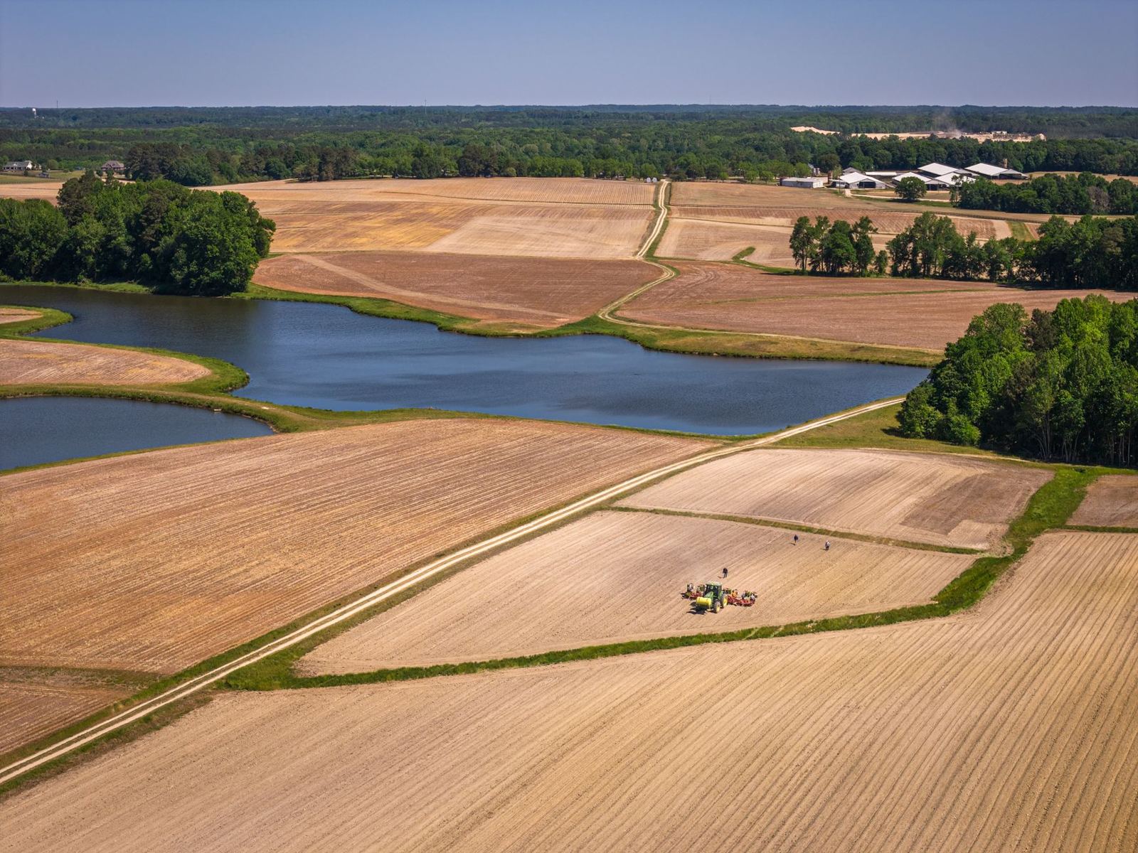 Aerial of Eastern North Carolina row-crop farmland with irrigation pond