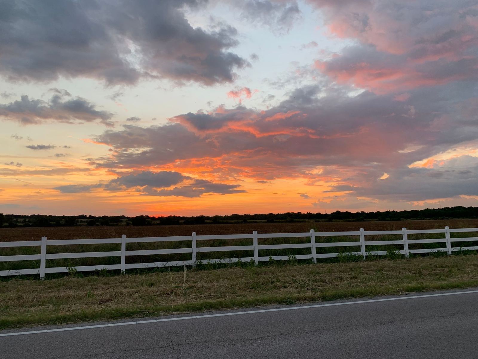Sell land fast in Texas — pastureland and white ranch fence at Texas sunset