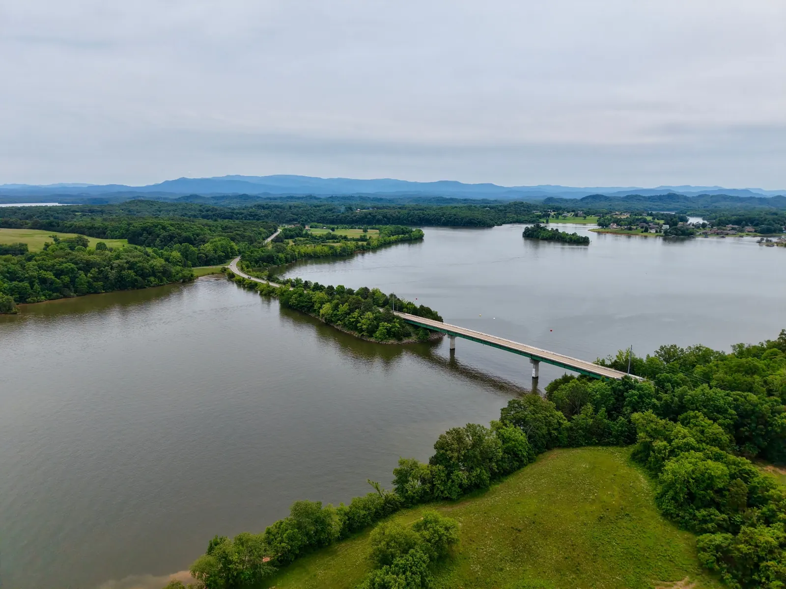 Tennessee River lake and bridge with Smoky Mountains in the distance — waterfront and view land